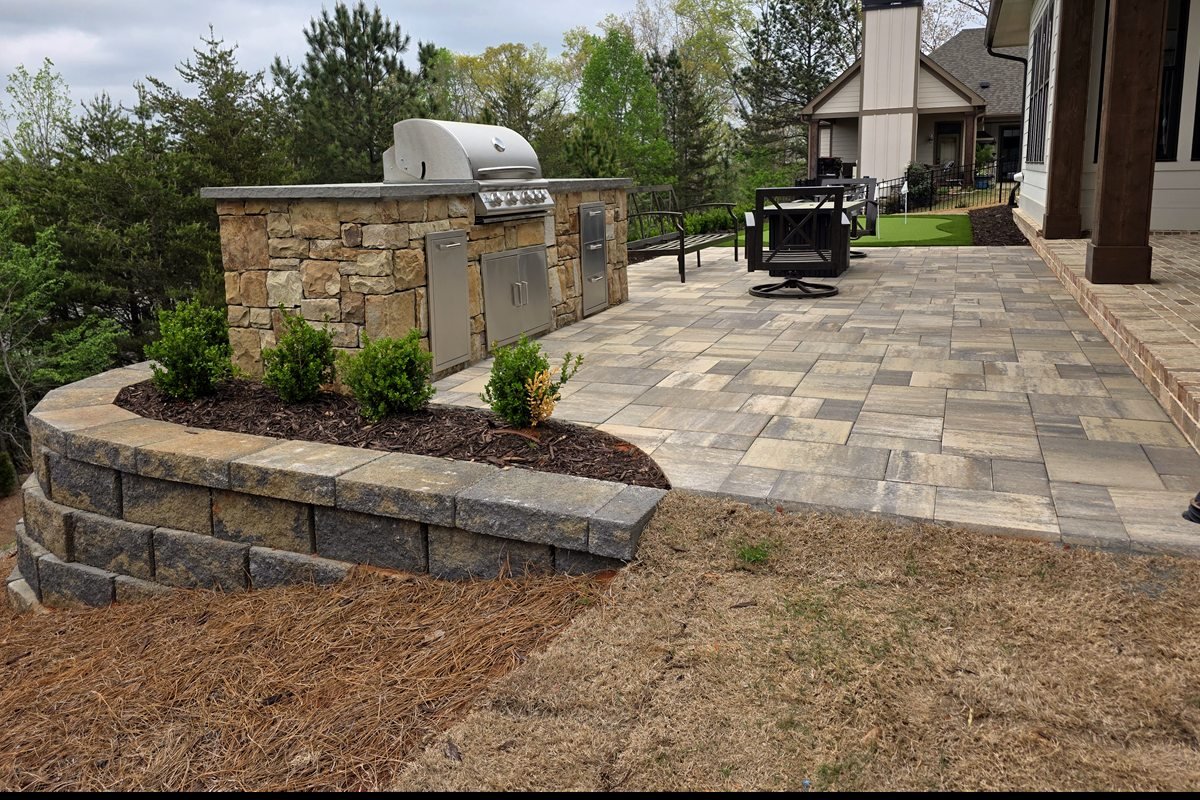 Custom stone outdoor kitchen, paver patio and stacked-stone retaining wall on Lake Lanier, North Georgia