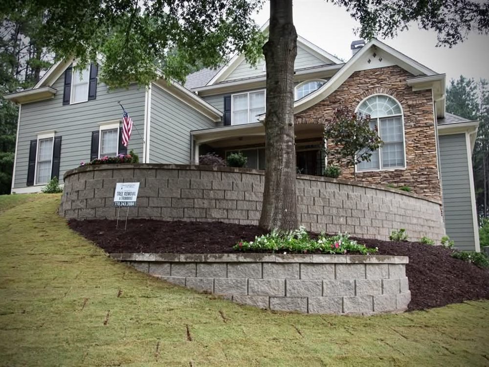 Tiered modular block retaining wall with a mulch bed and lawn