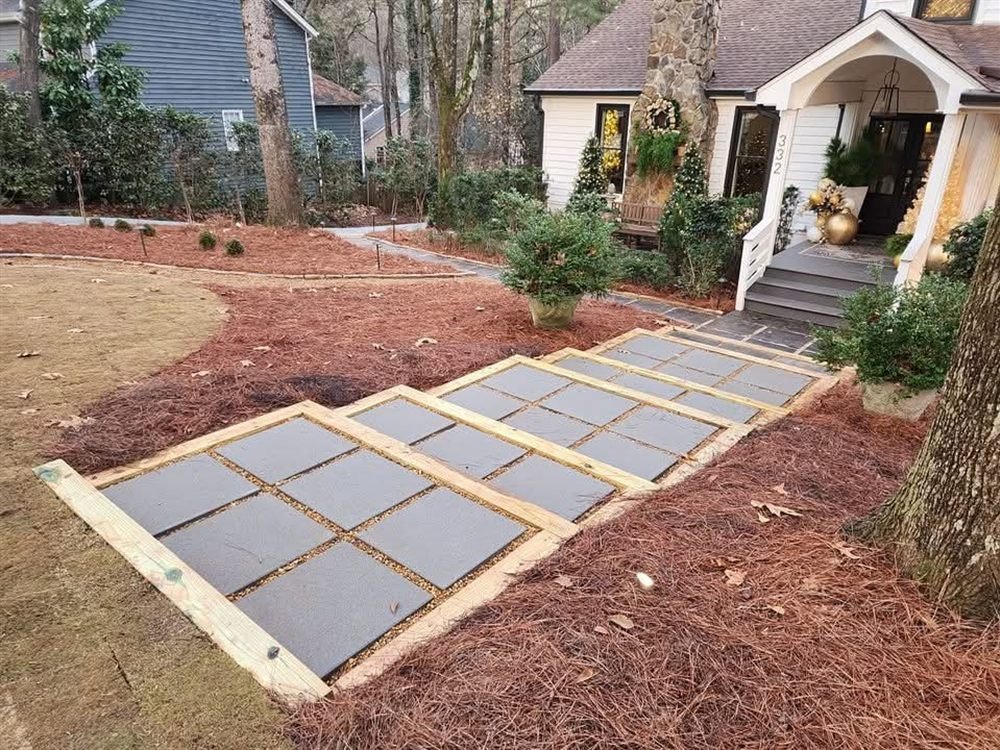 Timber-framed paver walkway leading to a cottage entrance